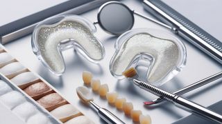 Two clear teeth-whitening trays beside a tooth shade guide